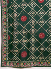 Green fabric with intricate white embroidery and red circular patterns on a white background