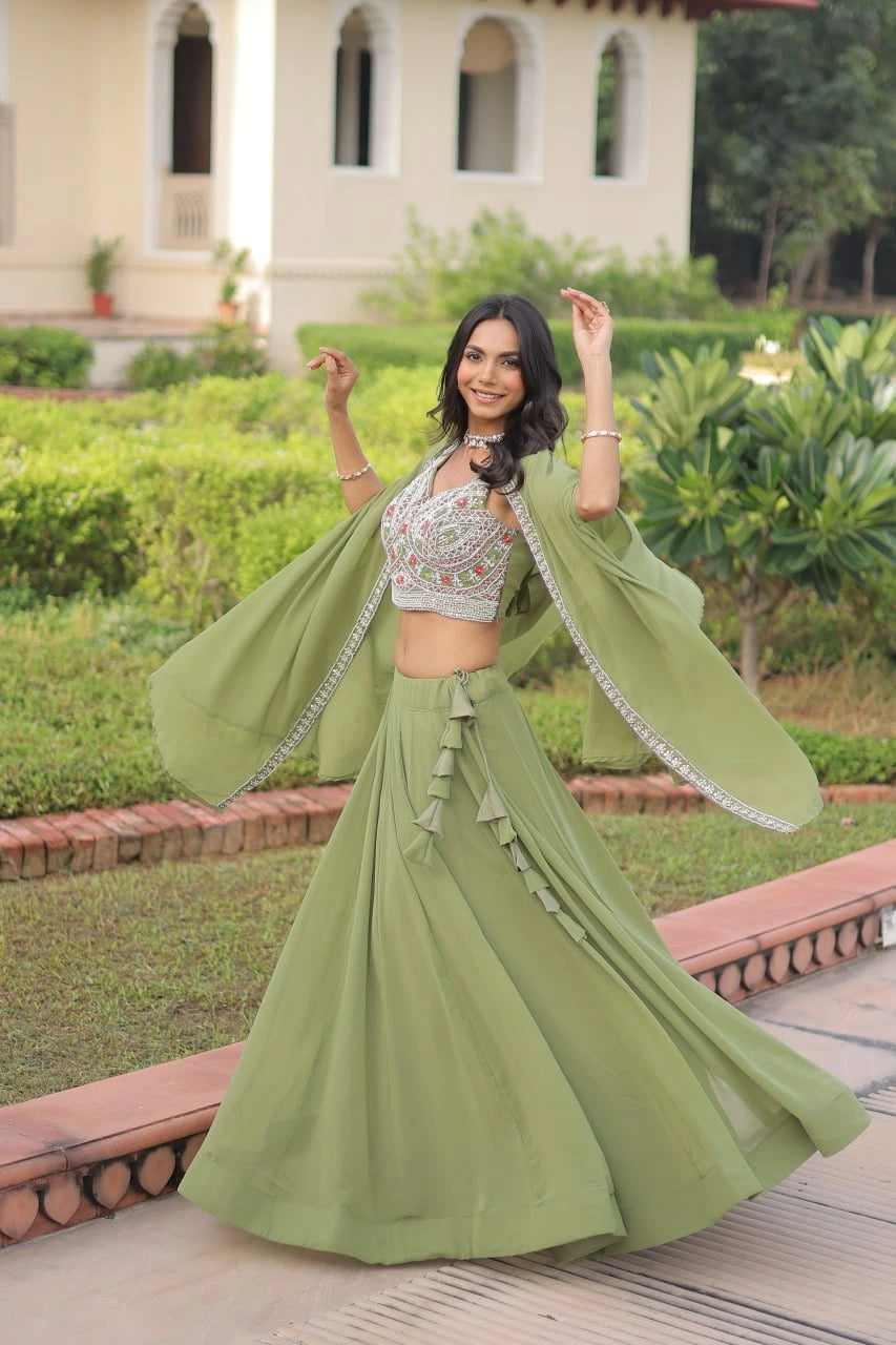 Woman in a green traditional outfit standing in a garden with a building in the background