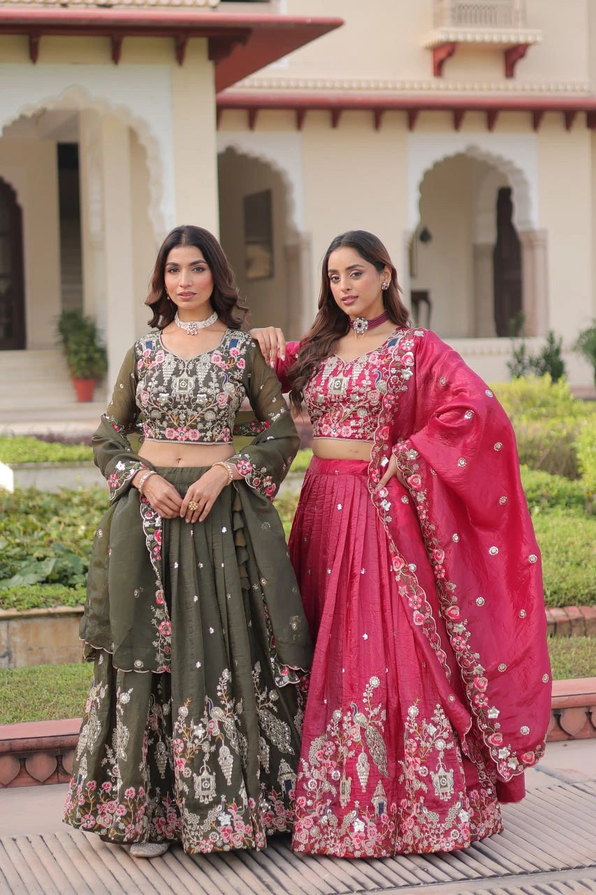 Two women in traditional outfits standing in front of a building with arches.