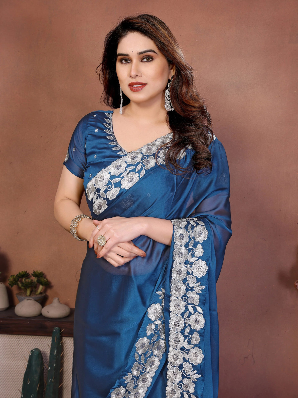 blue silk saree featuring heavy embroidered floral borders