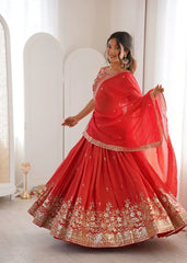 Woman in a red traditional outfit with gold embroidery in a minimalistic setting