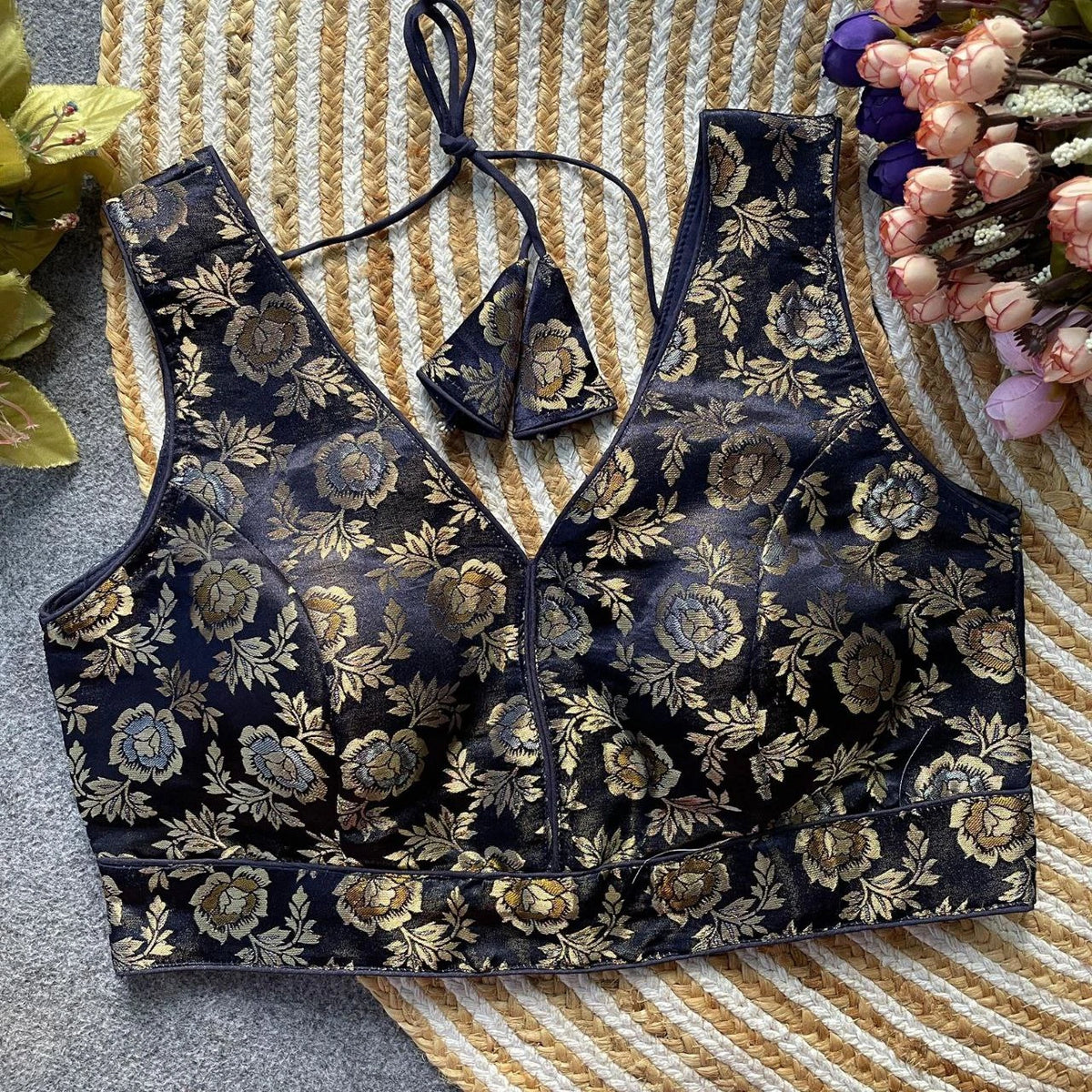 Floral patterned bralette and panties set on a textured surface with flowers.