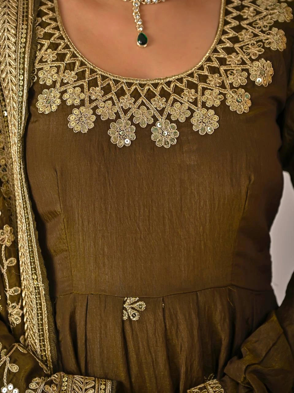 Brown garment with intricate gold embroidery and embellishments