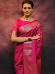 Woman wearing a pink saree with a textured background