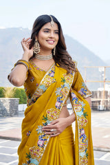 Woman wearing a yellow saree with a colorful border outdoors