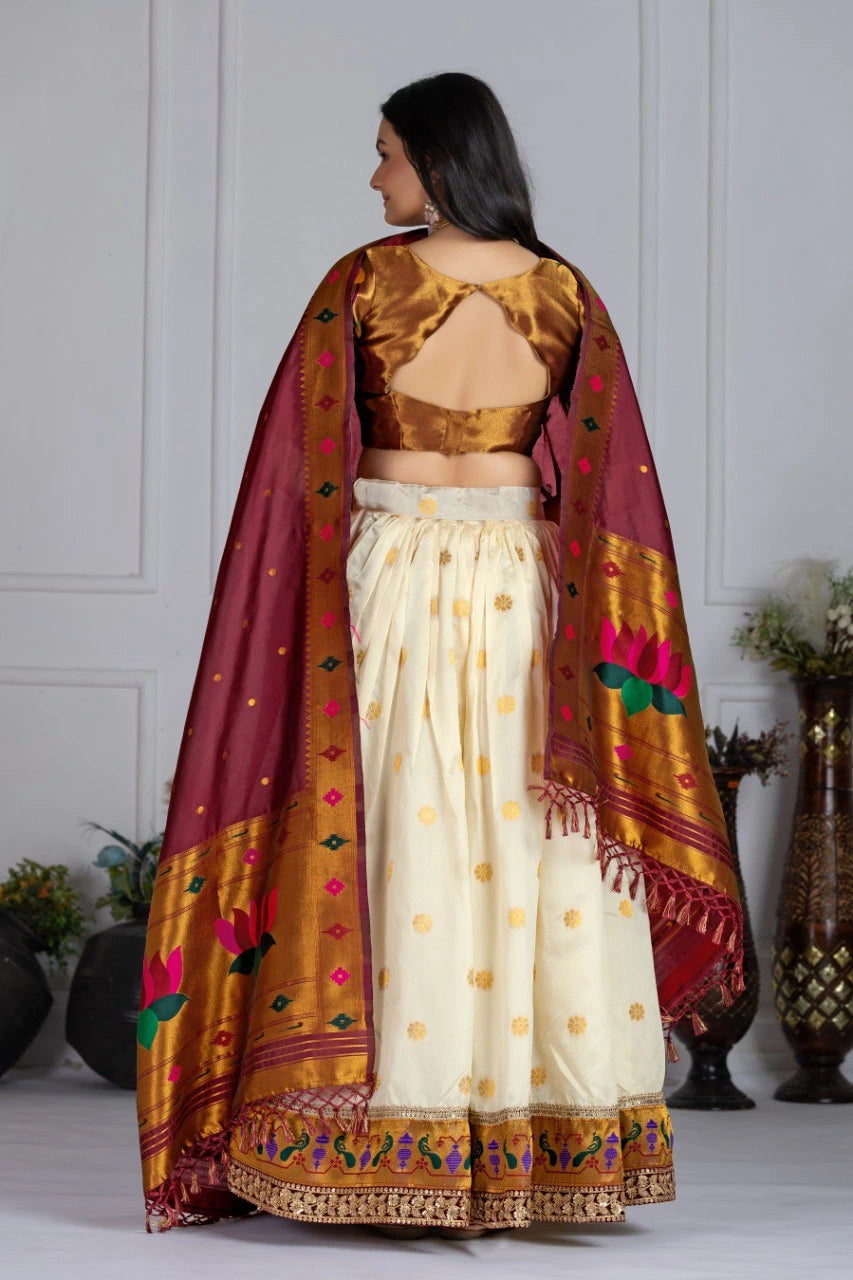 Woman wearing a traditional outfit with a maroon dupatta in an indoor setting