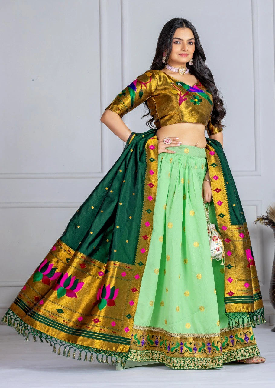 Woman wearing a traditional green and gold saree with a white background
