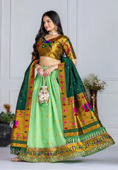 Woman wearing a traditional green and gold saree with a white background
