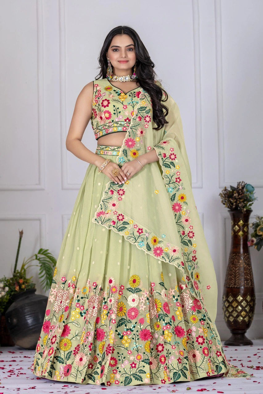 Woman wearing a floral embroidered lehenga in a decorated indoor setting