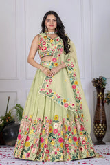 Woman wearing a floral embroidered lehenga in a decorated indoor setting
