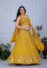 Woman wearing a yellow embroidered traditional outfit with a white background