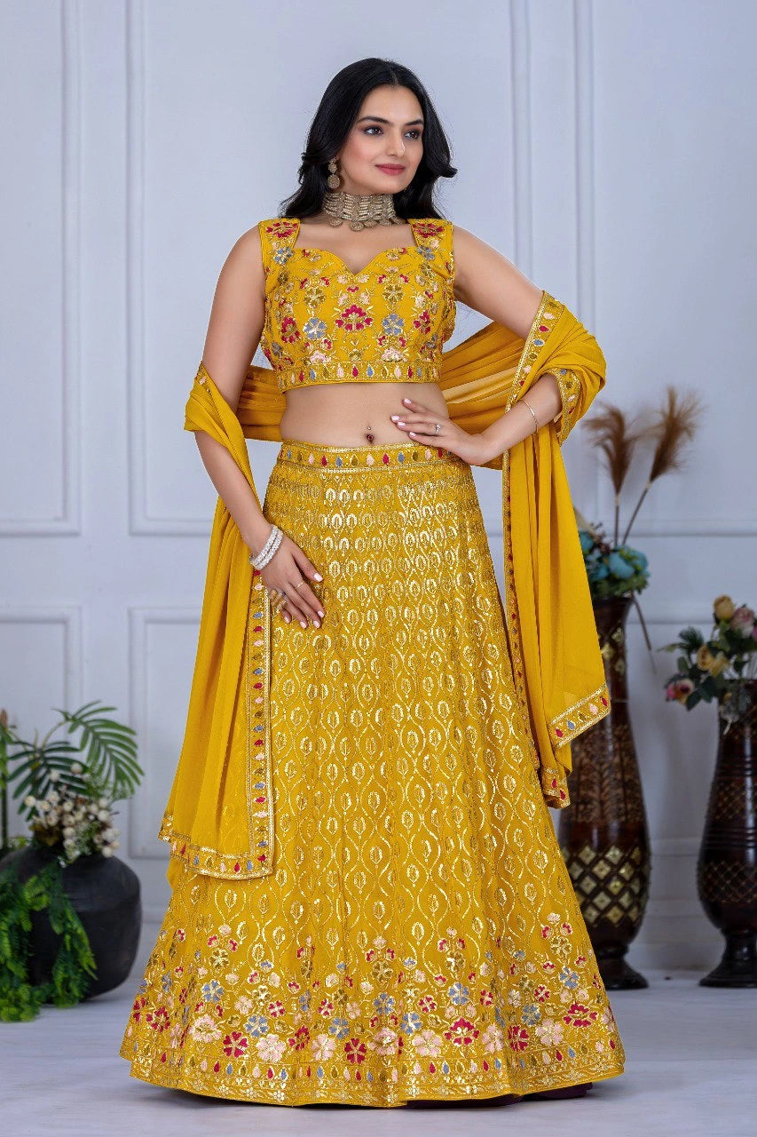 Woman wearing a yellow embroidered traditional outfit with a white background