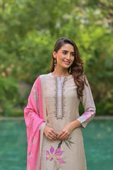 Woman wearing a beige embroidered kurta with pink dupatta in a garden setting