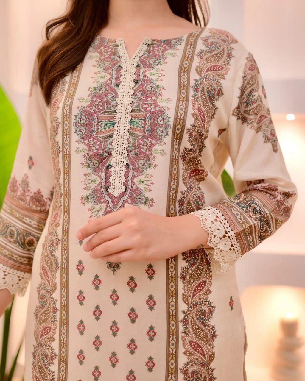Beige embroidered traditional outfit with intricate patterns