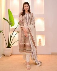 Woman in a traditional outfit standing in a well-lit room with decorative elements.