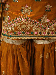Close-up of a brown embroidered garment with intricate patterns and colors.