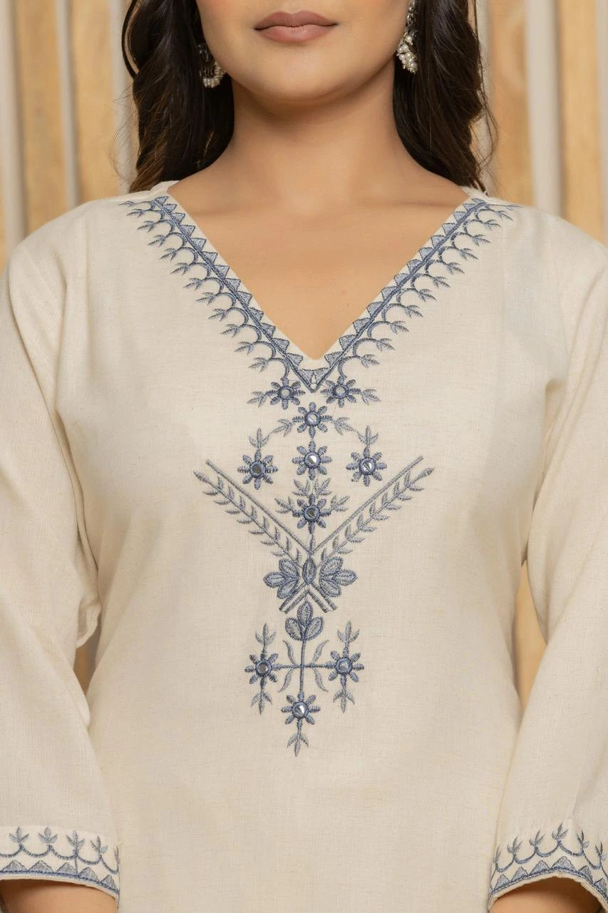 Beige kurta with blue floral embroidery on a plain background