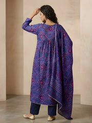Woman wearing a purple patterned kurta with a plain background
