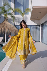 Woman in a yellow traditional outfit standing by a poolside.