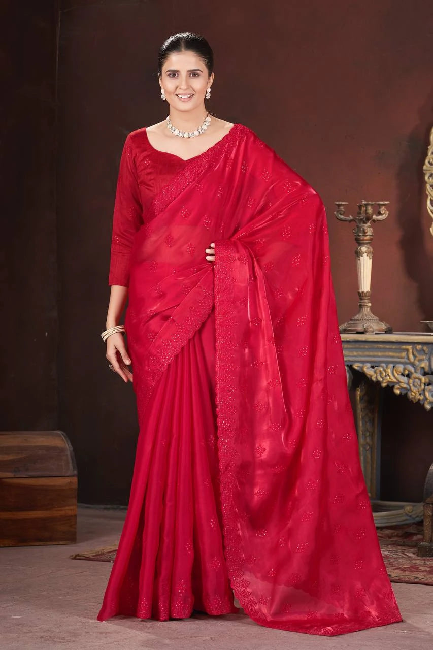 Woman wearing a red saree with a dark background