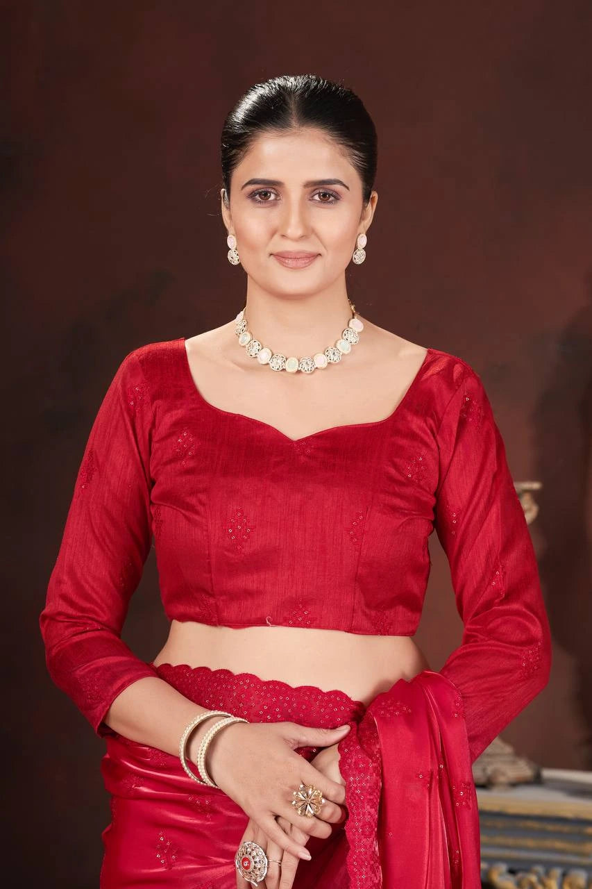 Woman in a red traditional outfit with jewelry against a dark background