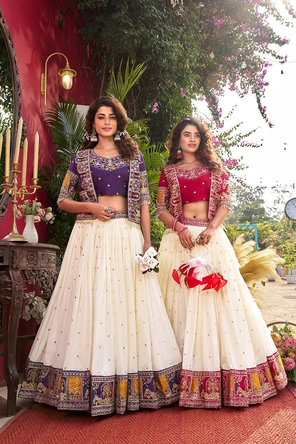 Two women in traditional outfits standing outdoors with decorative elements.