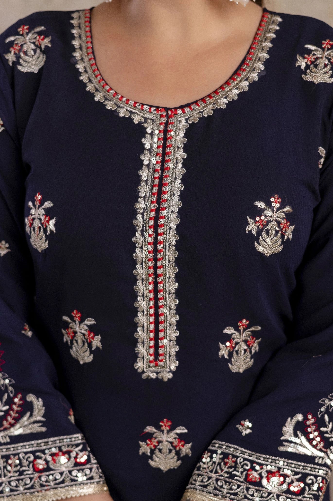 Navy blue embroidered garment with intricate patterns