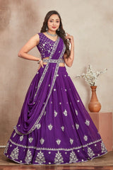 Woman wearing a purple embroidered traditional outfit with a plain background