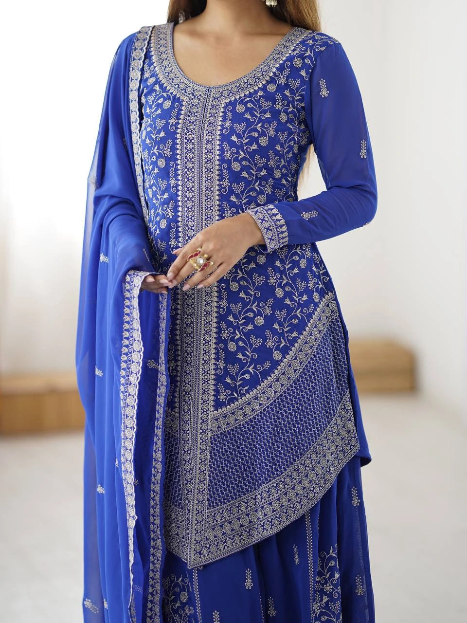 Blue embroidered traditional outfit with a white background