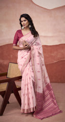 Woman wearing a pink saree with a matching blouse against a beige background