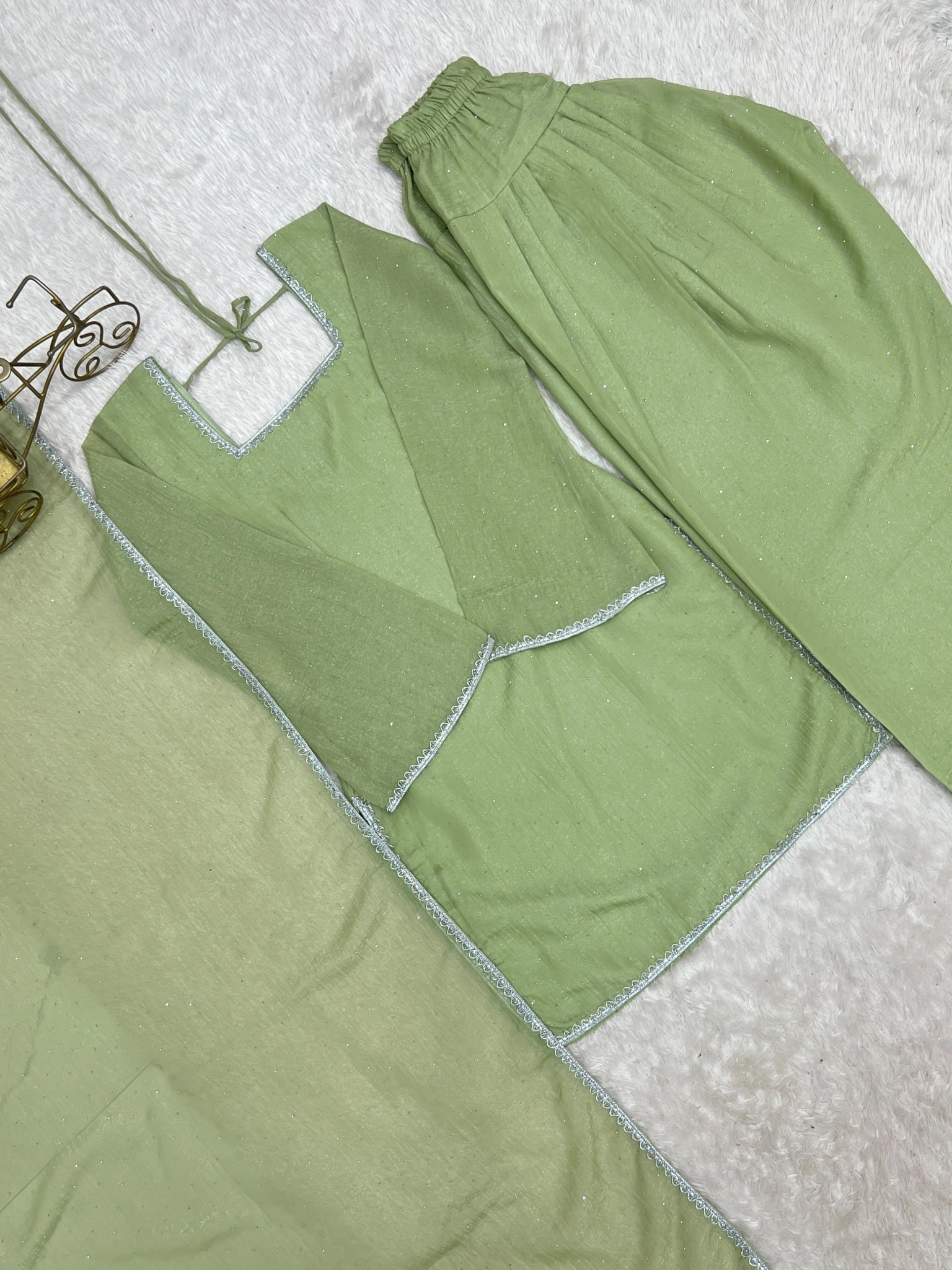 Pista green suit flat lay - back tie-up detail