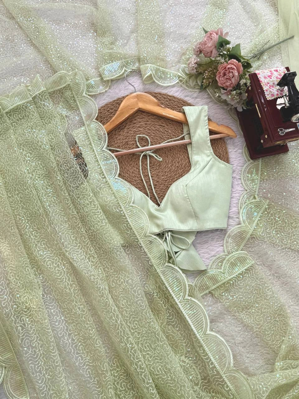 Pista net saree – blouse piece and sequin work flat lay