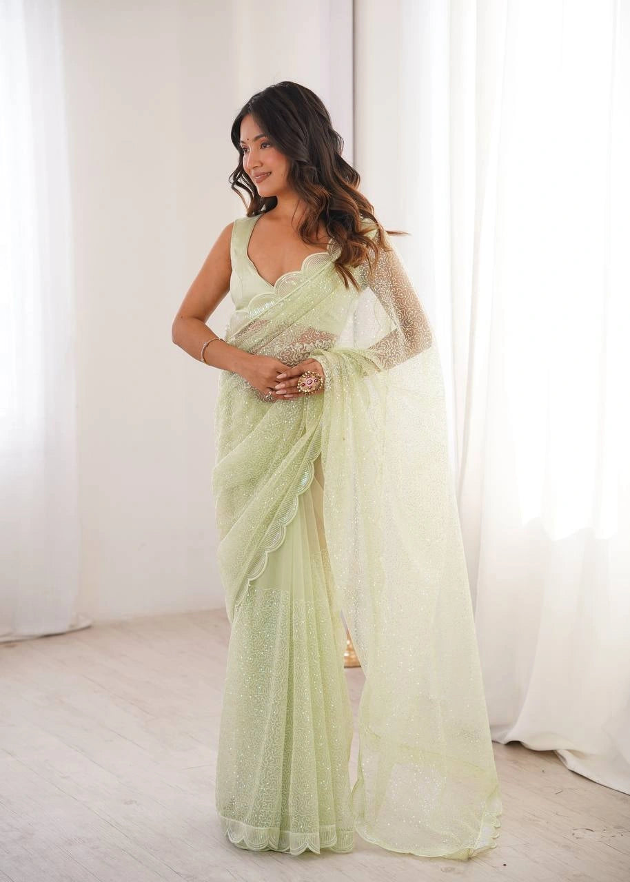Pista green net saree with scalloped border – model pose