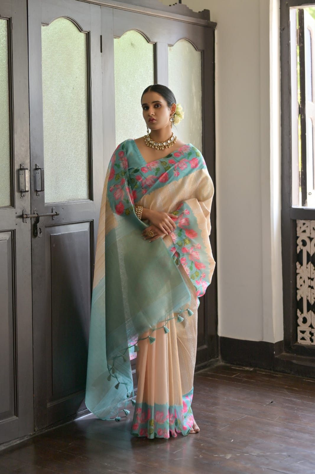 Elegant powder blue saree with zari work and contrasting floral border design