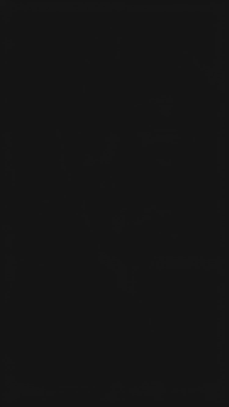 A woman models a vibrant Soft Tussar Silk Saree. The saree is maroon/deep rose pink with a wide, contrasting deep teal border and pallu featuring intricate traditional prints. She wears a teal blouse, a green beaded necklace, and is posed in a garden setting.