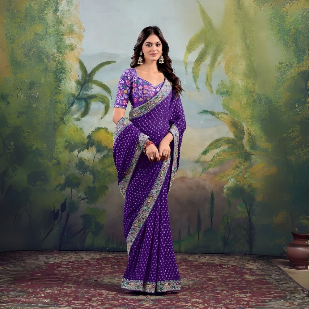 Woman wearing purple saree with floral embroidered border and matching blouse in studio backdrop