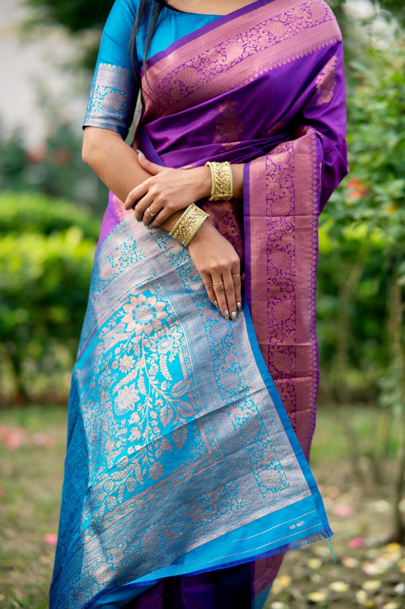 Purple saree with intricate zari work and blue border