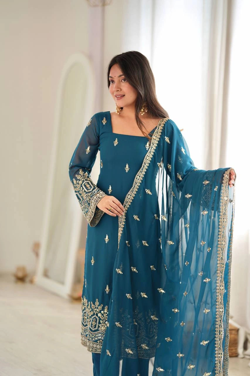 Rama Blue suit model holding embroidered booti dupatta showing zari border