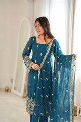 Rama Blue suit model holding embroidered booti dupatta showing zari border