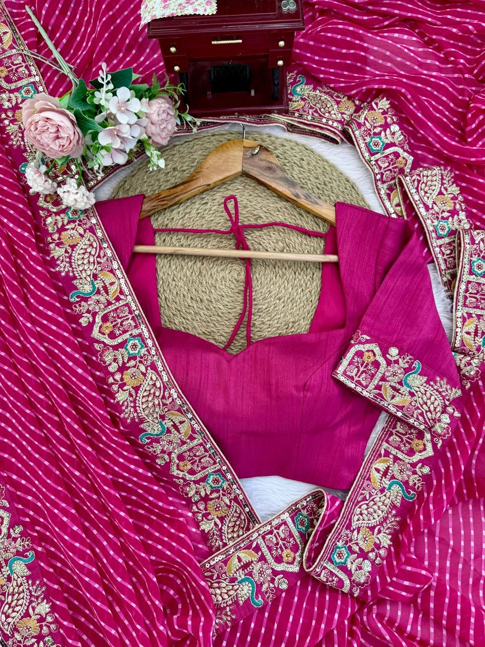 Rani pink saree border and blouse piece flat lay