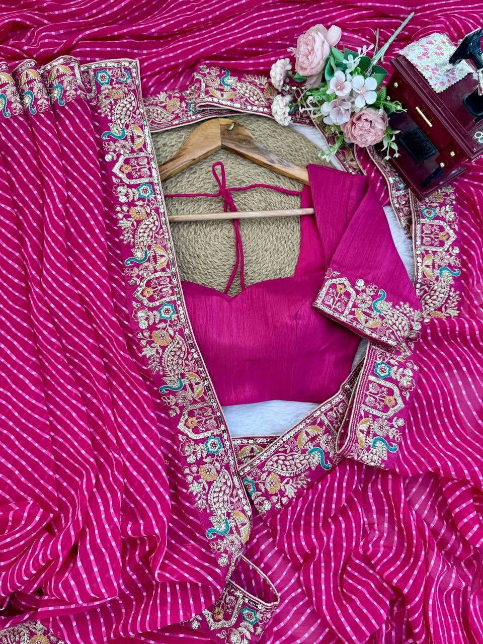 Rani pink saree embroidered pallu – flat lay