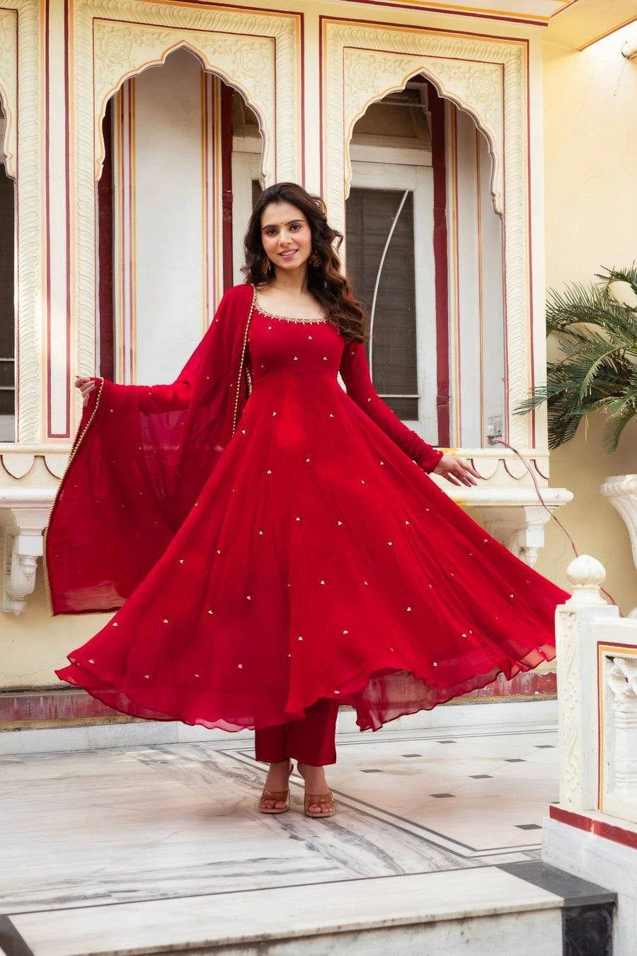 Red Embroidered Butti Anarkali Suit front view smiling model Faux Georgette KU290