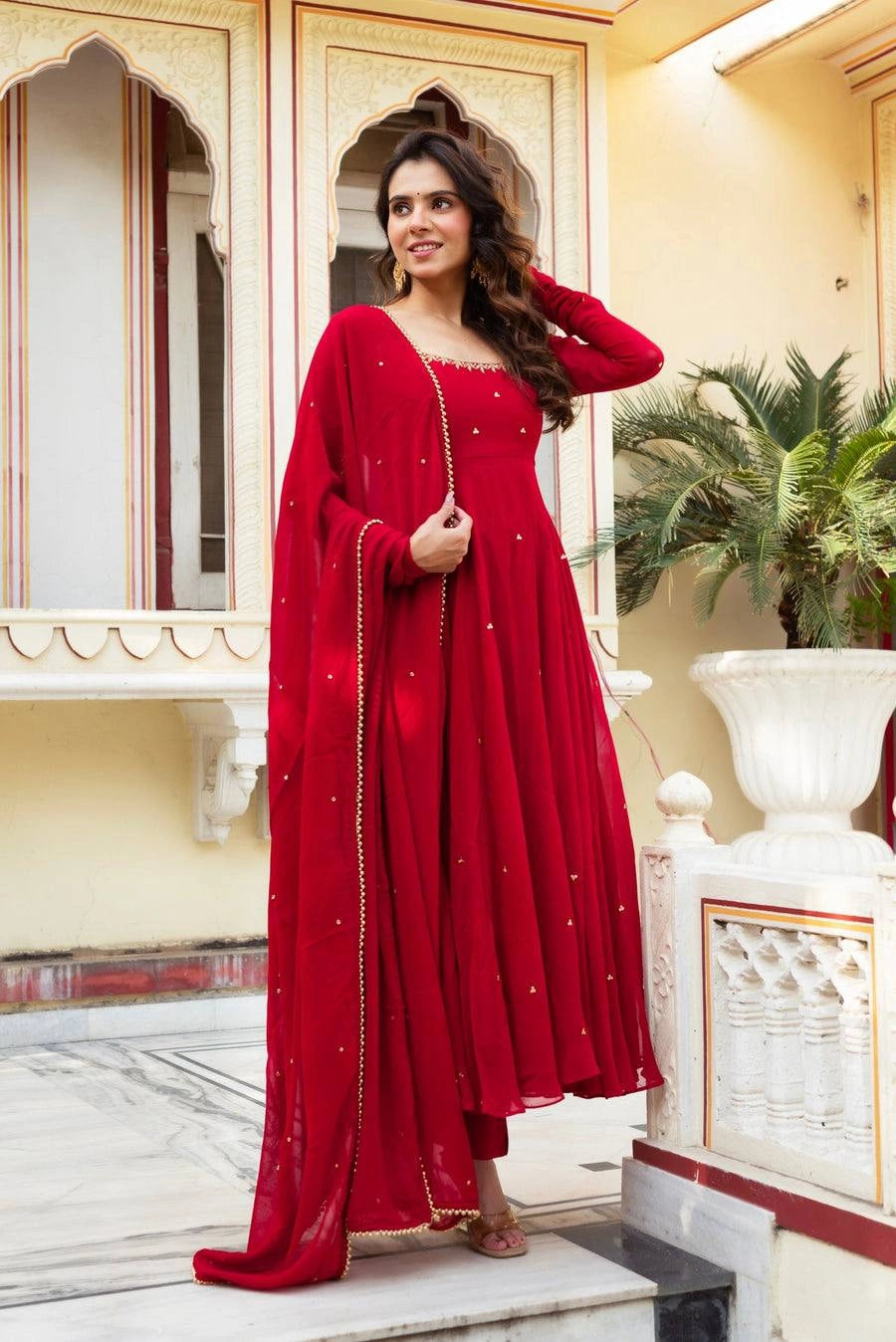 Red Embroidered Butti Anarkali Suit three quarter outdoor heritage location