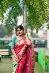 Woman wearing a red saree with intricate zari work, showcasing a traditional ethnic look.