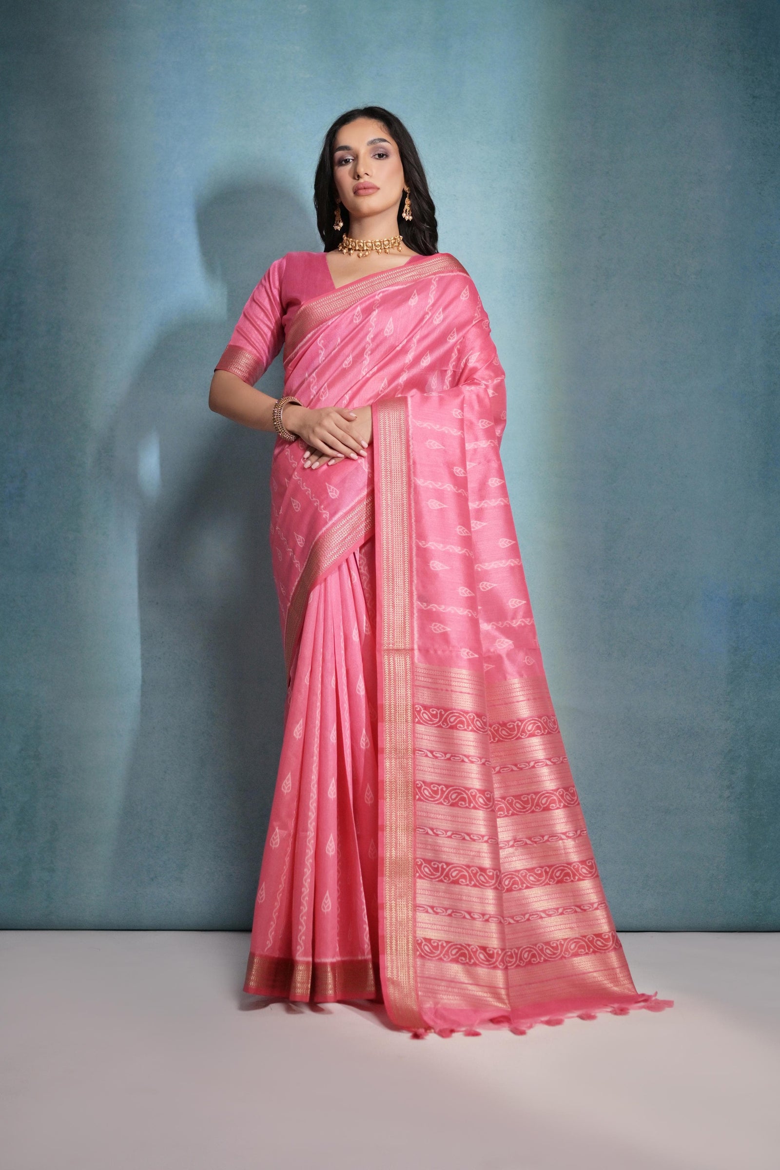 Tulip pink saree with intricate ikkat and zari weaving, showcasing traditional handloom textile craftsmanship