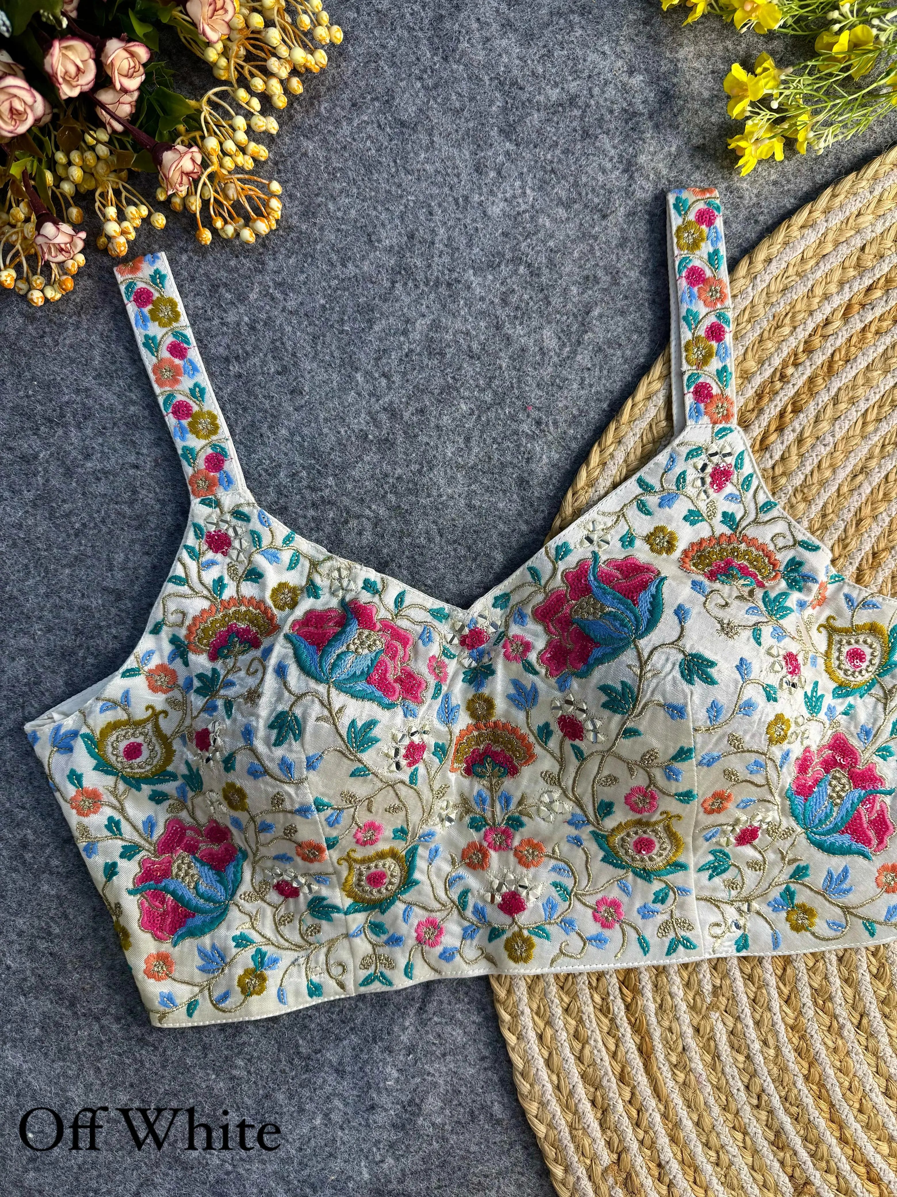 Elegant white silk blouse adorned with intricate embroidery and shimmering sequin work, perfect for formal and festive occasions