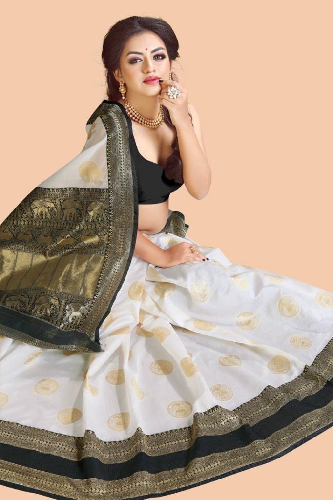 White jacquard saree with golden circular motifs featuring black crop blouse and ornate elephant design pallu with gold border traditional Indian ethnic wear styled with pearl necklace and statement ring