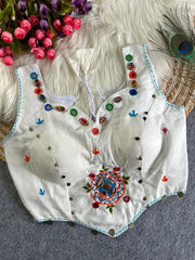 White Multi Thread Mirror Work Blouse – front flat lay showing sweetheart neckline, cowrie shells and vibrant mirror embellishments