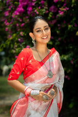 White transparent organza saree with coral flamingo pattern print orange red border paired with matching blouse turquoise