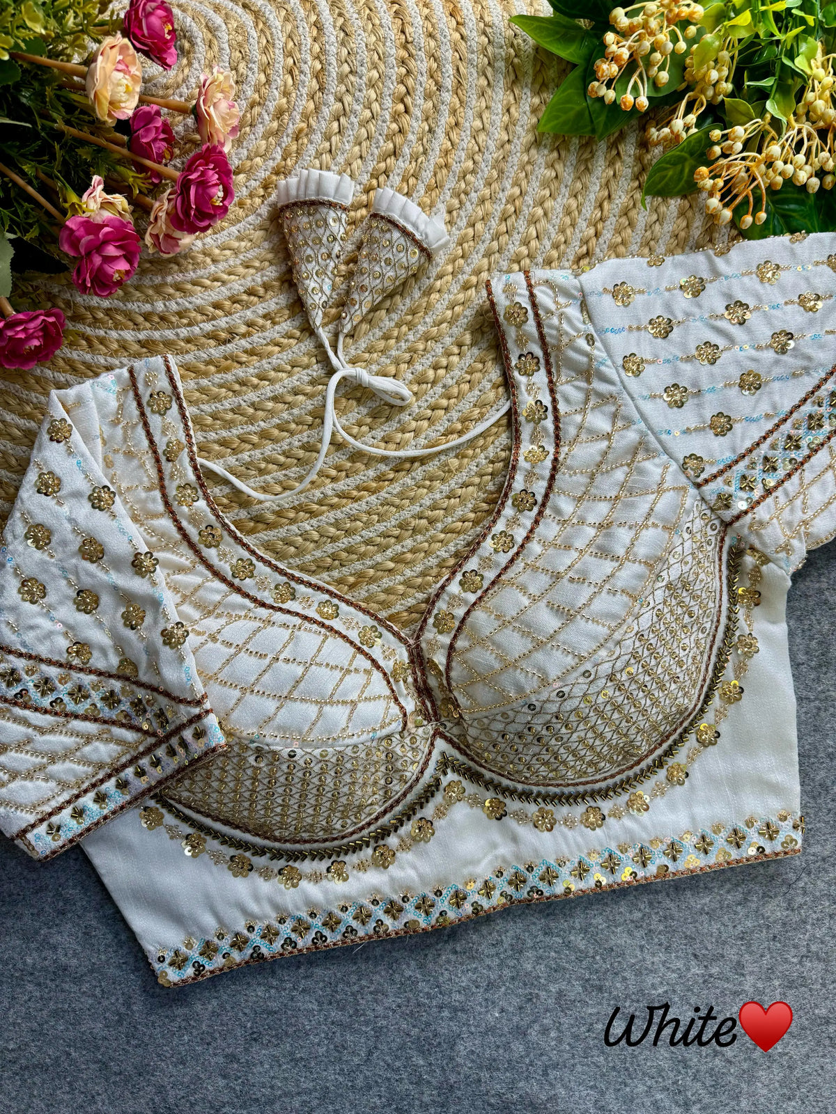 This soft silk blouse features delicate white sequins and ornate coding thread work, adding a touch of elegance to any outfit. The lightweight material will keep you comfortable and stylish throughout the day. Elevate your wardrobe with this timeless piece.